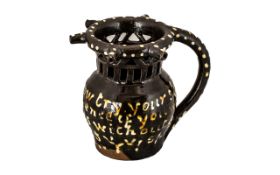 A 19th Century dated 1875 Treacle Glazed Puzzle Jug, with text 'Gentlemen now try your skill,