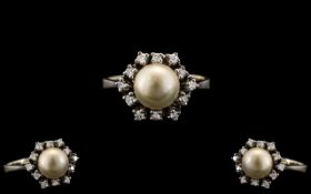 Ladies 14ct White Gold Stylish and Attractive Diamond and Pearl Set Dress Ring. The Central Pearl