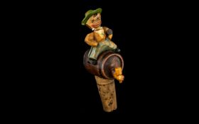 Black Forest Carved and Painted Novelty Wine Bottle Stopper, Depicting a Boy Sat on a Barrel of