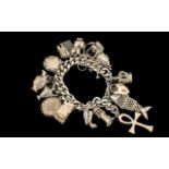 A Superb Heavy and Impressive Sterling Silver Vintage Charm Bracelet - Loaded with 18 Silver Charms.