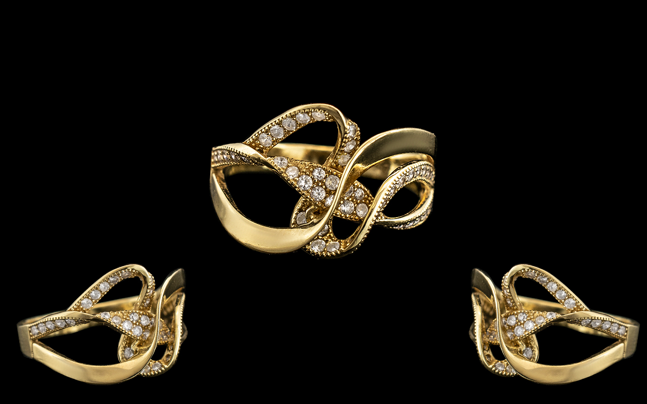 18kt Gold Ladies Ring with a ribbon design set with small diamonds; weight 3.