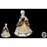 Spode Porcelain Figurine depicting a lady holding a cat, dressed in traditional robes.