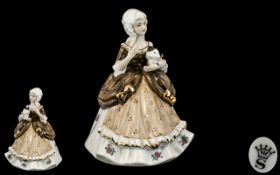 Spode Porcelain Figurine depicting a lady holding a cat, dressed in traditional robes.