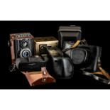 Five Assorted Vintage Cameras with accessories and booklets on camera settings,