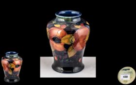 William Moorcroft Signed Small Shaped Vase ' Pomegranates ' Design on Blue Ground. c.1920's.