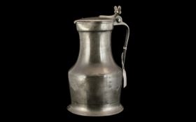 18th Century Pewter Flagon of large size, the handle grip with a two acorn moulded knop,