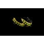 Peridot Hoop Earrings, each earring having a full ring of round cut peridots from the front of the