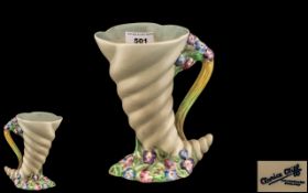 Clarice Cliff Vase, cornucopia shaped, in cream with handle and floral decoration,