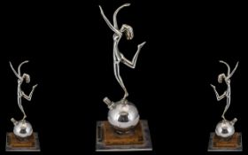 An Art Deco Period Chrome Cigarette Lighter, depicting a naked dancing girl. 9" tall.