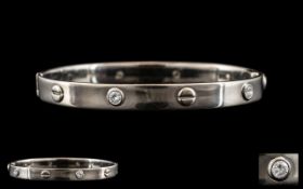 Cartier Style - 18ct White Gold Diamond Set Hinged Bangle. Marked 750.