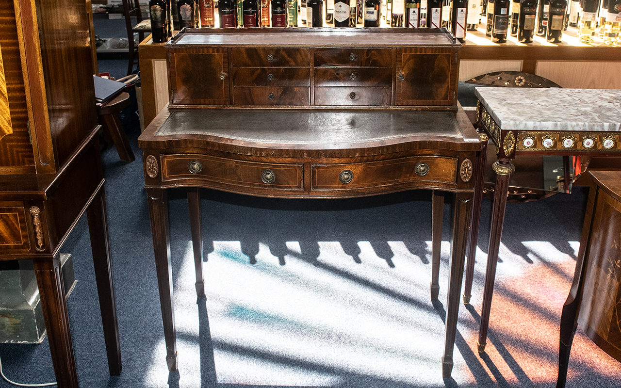 A Mid 20th Century Ladies Writing Desk, with a grey leather tooled top,