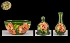 William Moorcroft Signed Trio of Items. In The ' Coral Hibiscus ' Design on Green Ground.