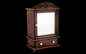 Small Mahogany Cabinet with mirrored door and drawer beneath, decorative fretwork to top,