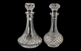 Two Cut Glass Decanters, both with decorative stoppers, each measuring 25 cm tall.