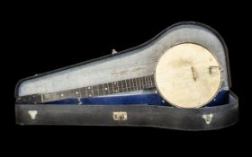 Vintage Four String Banjo in black carrying case.