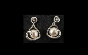 White Fresh Water Pearl Heart Shaped Drop Earrings, an openwork heart, set at an angle,