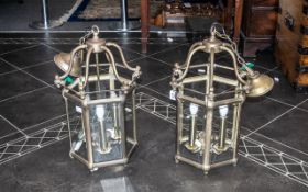 A Pair of Reproduction Brass Hanging Lanterns Electrified with Bevel glass panels in the