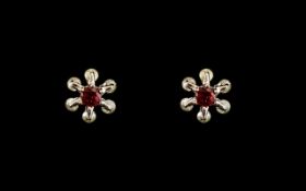 Floral Shaped Earrings with Diamond Chips and ruby centre stones, for pierced ears.