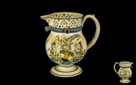 Staffordshire Puzzle Jug in cream with handpainted floral decoration, (some damage to neck).