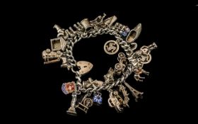 A Vintage Sterling Silver Charm Bracelet Loaded with 28 Silver Charms,