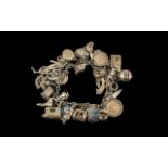 A Vintage Sterling Silver Charm Bracelet Loaded with over 25 Silver Charms, Various Subjects.