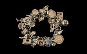 A Vintage Sterling Silver Charm Bracelet Loaded with over 25 Silver Charms, Various Subjects.