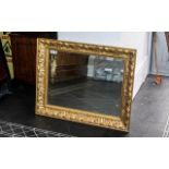 Fine Quality Giltwood Frame with a floral design, enclosing a bevelled mirror, 24 inches (app.