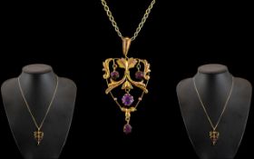 Edwardian Period 9ct Gold Openwork Pendant set with amethysts of attractive appearance, with later