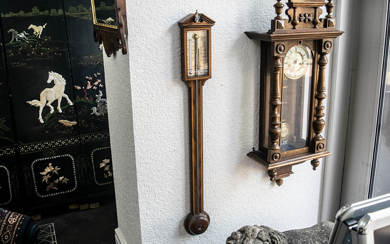 Comitti and Son London Stick Barometer, mahogany case with inlay, of typical form.