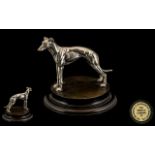 Model of Greyhound raised on wooden plinth,