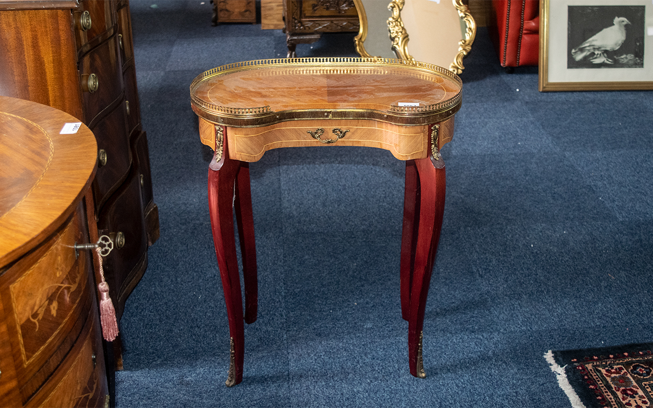 A Small French Reproduction Kidney Shaped Ormolu Mounted Side Table terminating on cabriole legs.