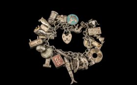 A Vintage Sterling Silver Charm Bracelet - Loaded with 25 Silver Charms,