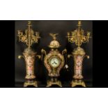 A Three Piece Ormolu Garniture Set, central clock, in pink enamels with floral decoration,