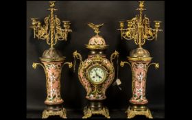 A Three Piece Ormolu Garniture Set, central clock, in pink enamels with floral decoration,