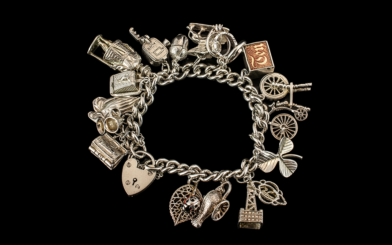 A Vintage - Good Quality Sterling Silver Charm Bracelet Loaded with 17 Sterling Silver Charms,