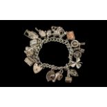 A Vintage - Good Quality Sterling Silver Charm Bracelet Loaded with 17 Sterling Silver Charms,