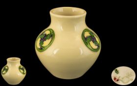 Moorcroft Modern Small Cabinet Vase, ivory glazed, decorated with circular floral design.