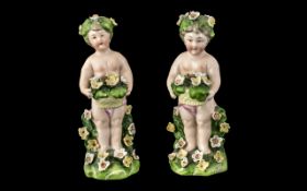 Pair of Antique Dresden Type Figures of Small Garlanded Cherubs. Height 5 Inches. A/F.