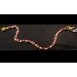 Ruby Tennis Bracelet, a line of oval cut rubies, red with a deep pink tone, making an unusual,