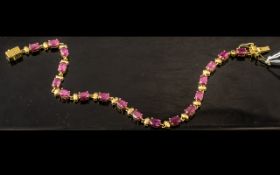 Ruby Tennis Bracelet, a line of oval cut rubies, red with a deep pink tone, making an unusual,