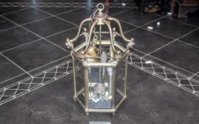 A Reproduction Brass Hanging Lantern Electrified with Bevel glass panels in the traditional English