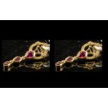 Ruby Triple Drop Earrings, each earring comprising three graduated pear cut rubies,