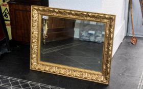 Fine Quality Giltwood Frame with a floral design, enclosing a bevelled mirror, 24 inches (app.60cms)