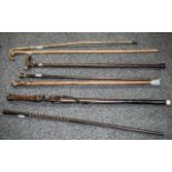 Seven Various Walking Sticks comprising two carved African figural sticks, a carved,