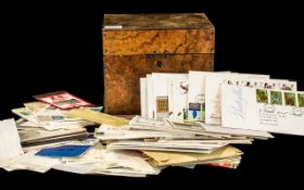 An Antique Walnut Hinged Box containing a small quantity of stamps to include First Day Covers,