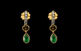 A Pair of 18ct Gold Diamond and Emerald Drop Earrings five round brilliant cut diamonds above an