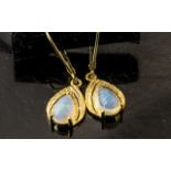 Pair of Opal Drop Earrings, pear cut solitaire opal cabochons, each over .