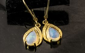 Pair of Opal Drop Earrings, pear cut solitaire opal cabochons, each over .