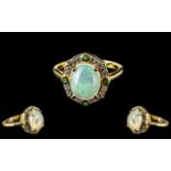 Opal and Emerald Halo Ring, a wonderfully domed cabochon cut opal of 2.