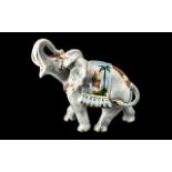 Porcelain Figure of an Elephant with trunk raised,